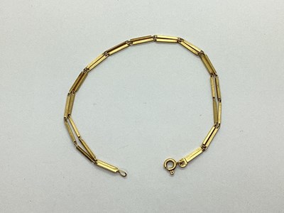 Lot 138 - A Double Row Bar Link Bracelet, stamped "750"...