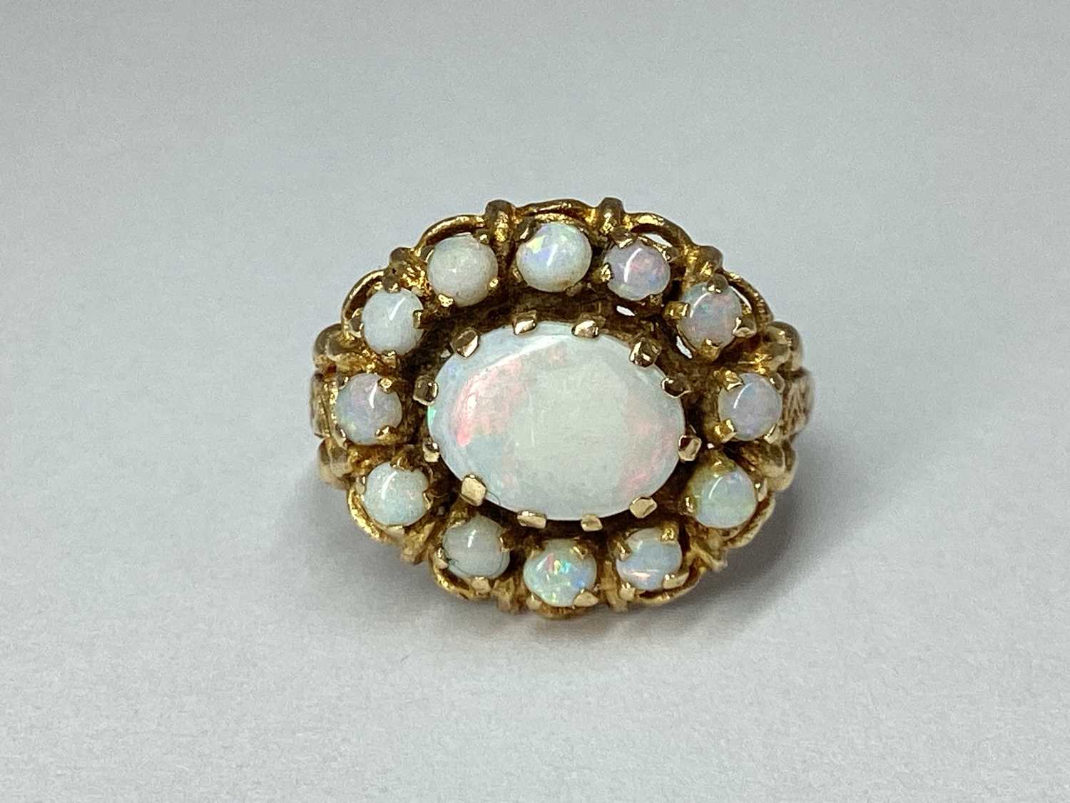 Lot 95 - A 9ct Gold Oval Cluster Ring, claw set...