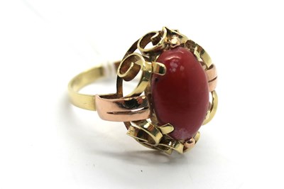 Lot 301 - A Coral Inset Dress Ring, oval cabochon claw...