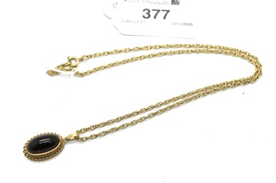 Lot 377 - A Cabochon Garnet Oval Pendant, collet set,...