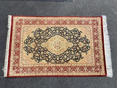 Lot 1483 - Qum Silk Tasseled Rug, with central Indian...