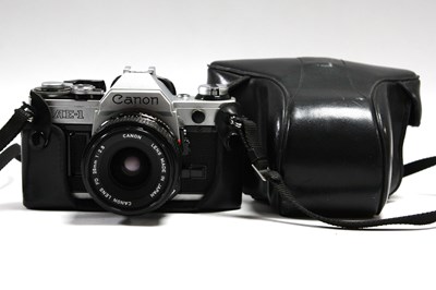 Lot 819 - Canon AE-1 35mm SLR Film Camera with attached...