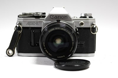 Lot 822 - Canon AE-1 35mm SLR Film Camera with attached...
