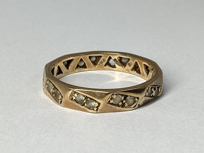 Lot 66 - A Faceted Style Inset Band, claw set...