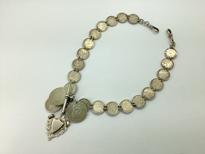 Lot 123 - A Coin Style Double Albert Chain, comprising...