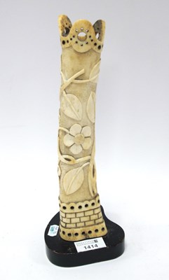 Lot 1414 - A bone vase carved with flowers on a hardwood...