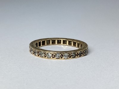 Lot 71 - A Full Eternity Style Ring, claw set...
