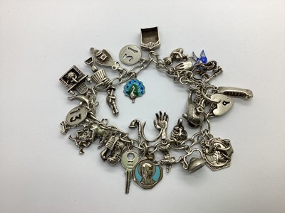 Lot 104 - A Curb Link Charm Bracelet, to heart shape...
