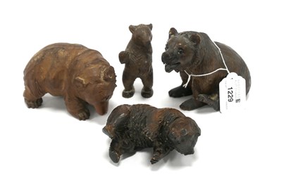 Lot 1229 - A Carved Wooden Seated Bear, with back paw...