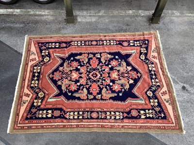 Lot 1506 - A Handmade Persian Rug decorated with a large...