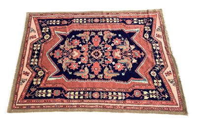 Lot 1284 - A Handmade Persian Rug decorated with a large...
