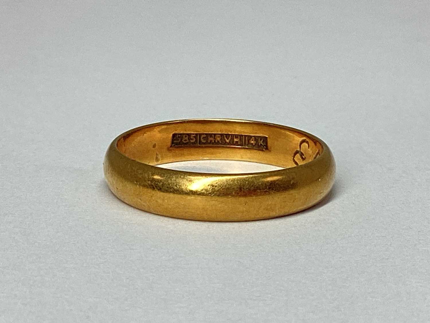 Lot 67 - A Plain Wedding Band, stamped "585 CHR.V.H.14K"...