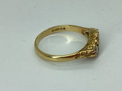 Lot 83 - An 18ct Gold Three Stone Emerald and Diamond...