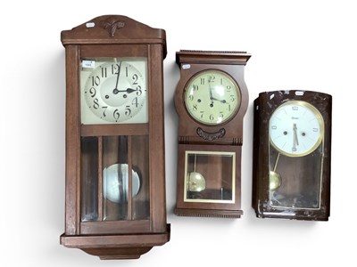 Lot 1565 - Three vintage wooden cased wall clocks,...