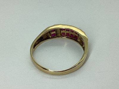 Lot 61 - A Modern 9ct Gold Channel Set Ring, the two...