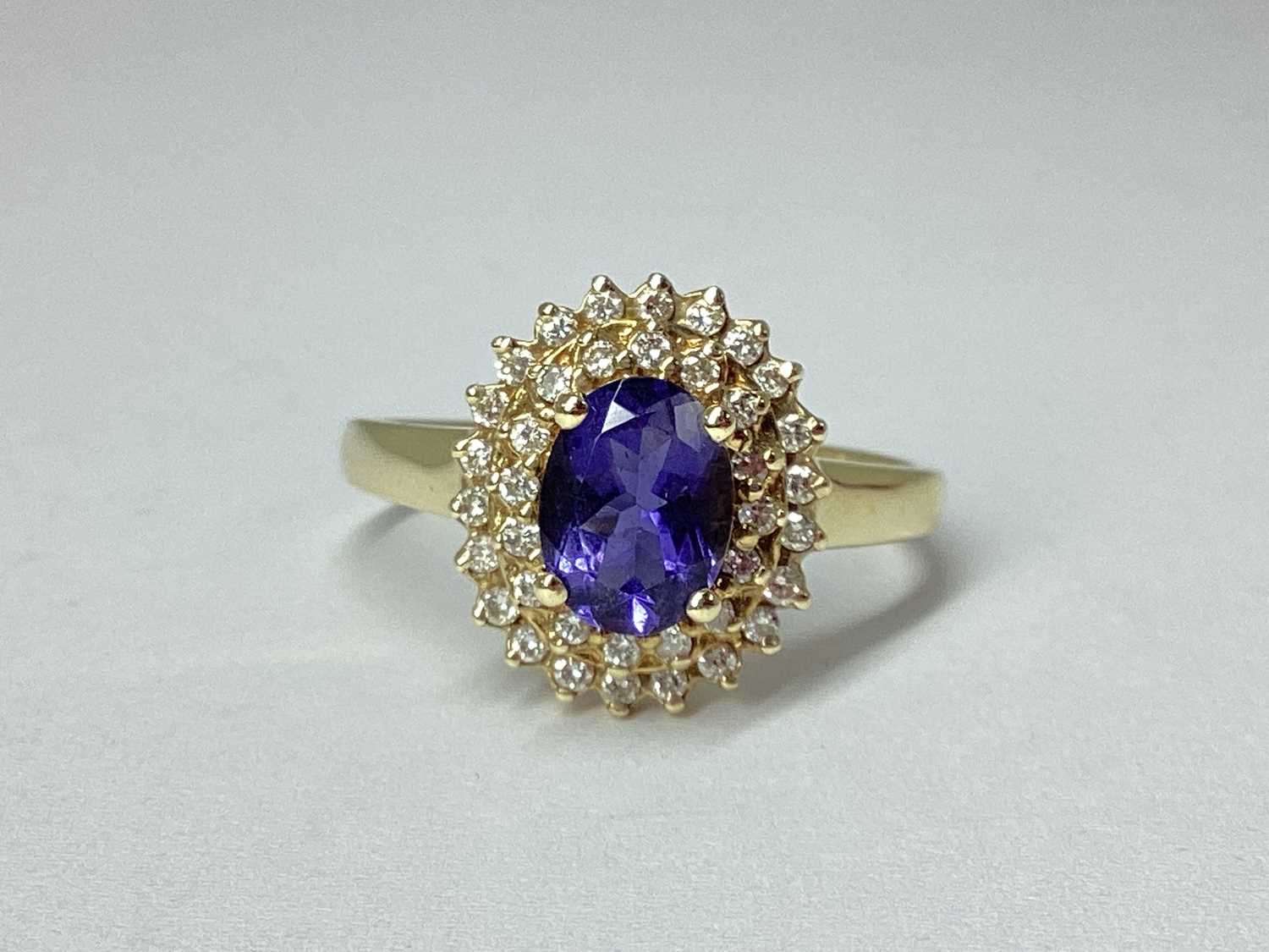 Lot 53 - A Modern Cluster Ring, oval four claw centre,...