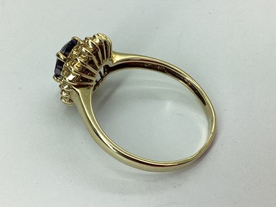 Lot 53 - A Modern Cluster Ring, oval four claw centre,...