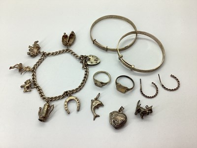 Lot 104 - A Hallmarked Silver Curb Bracelet, suspending...