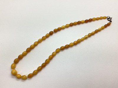 Lot 100 - A Graduated Amber Coloured Bead Necklace,...