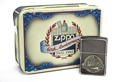 Lot 1287 - Zippo '60th Anniversary' Lighter in a metal...
