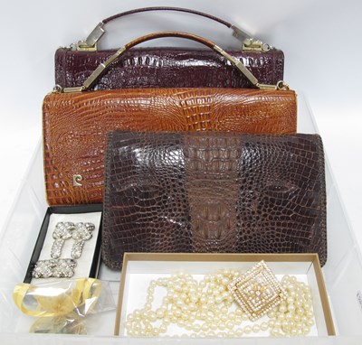 Lot 1379 - A Vintage Crocodile Skin Clutch Bag, two...