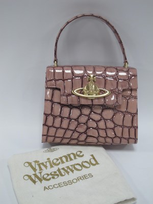 Lot 1387 - Vivienne Westwood; A Small Pink Croc Embossed...