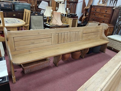 Lot 1561 - Pine Church Pew, with a panelled back, shaped...