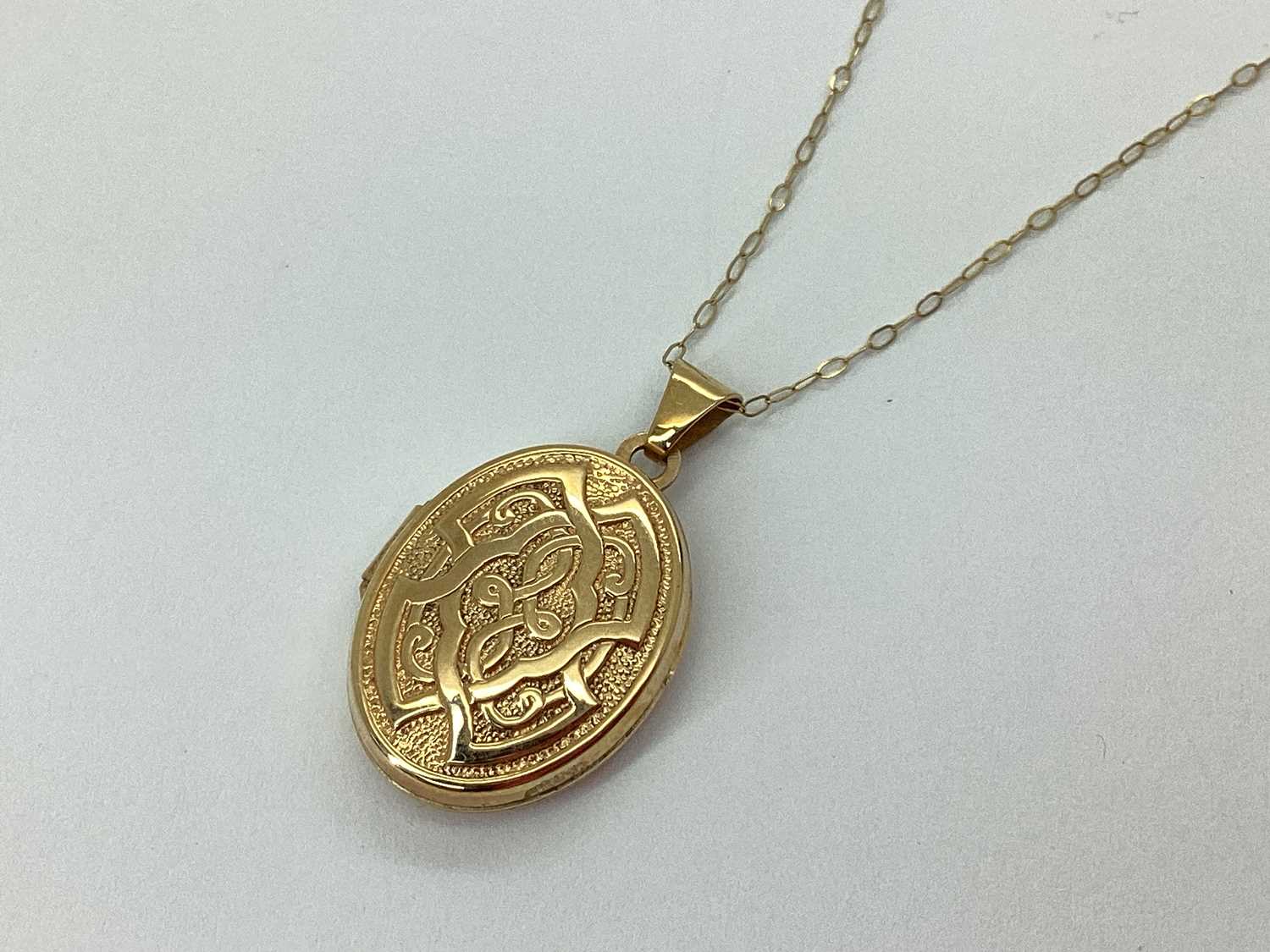 Lot 59 - A 9ct Gold Oval Celtic Style Locket, of...