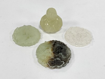 Lot 1264 - Three carved jade tokens, two matching designs...