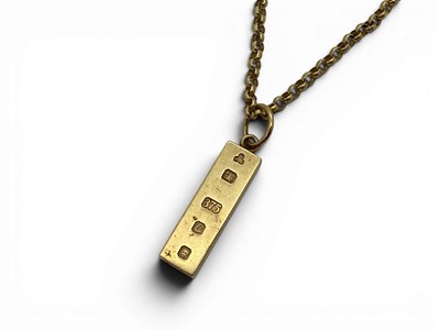 Lot 141 - A 9ct Gold Ingot Pendant, bearing feature...