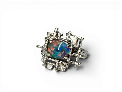 Lot 177 - An Abstract Style Ring, four claw cabochon...