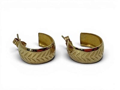 Lot 111 - A Pair of Chevron Patterned Huggy Style Hoop...