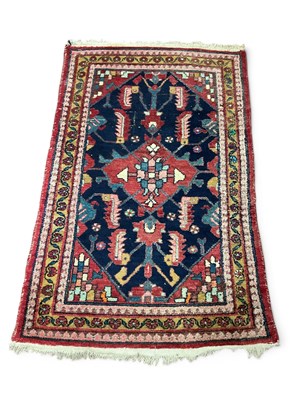 Lot 1518 - Persian (Iran) Wool Rug, with a red border,...