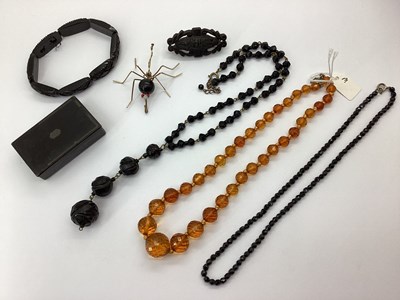 Lot 155 - A Carved Jet Coloured Drop Necklace, of...