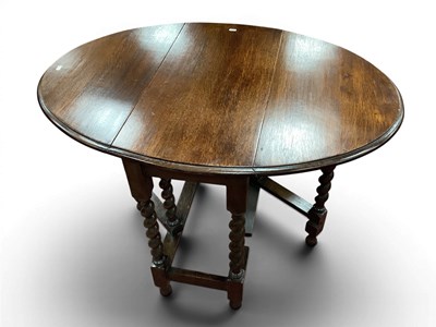Lot 1555 - A Gateleg Drop-Leaf Oak Dining Table, in...