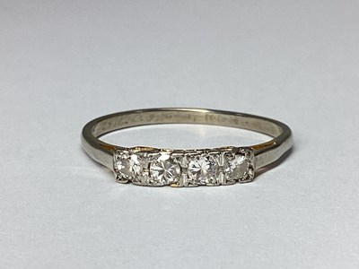 Lot 58 - A Dainty Four Stone Diamond Ring, inset claw...