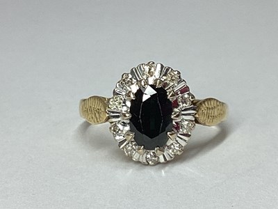 Lot 83 - A Dainty Sapphire and Diamond Oval Cluster...