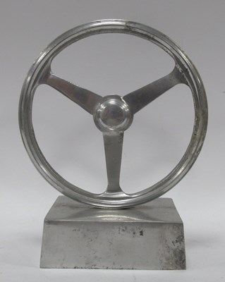 Lot 1327 - Wheel Mascot on Plinth, in aluminium, approx...