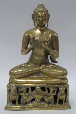 Lot 1318 - A Himalayan-style brass seated Buddha,...