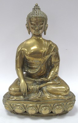 Lot 1312 - A Himalayan-style brass seated Buddha,...