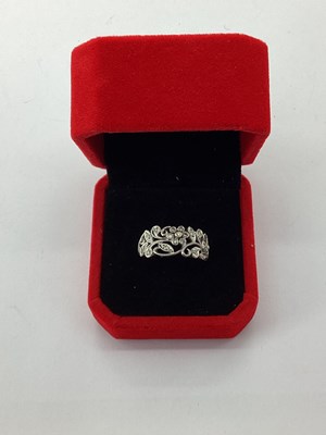 Lot 65 - A Modern Millegrain Inset Floral Style Ring,...