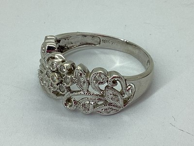 Lot 65 - A Modern Millegrain Inset Floral Style Ring,...