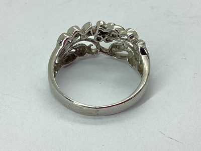 Lot 65 - A Modern Millegrain Inset Floral Style Ring,...