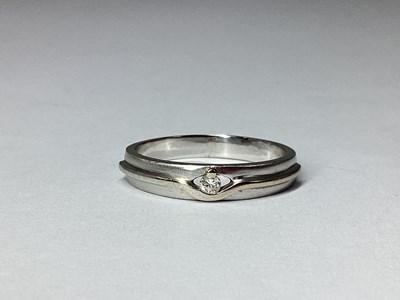 Lot 60 - A Modern Inset Band, the claw set highlight...
