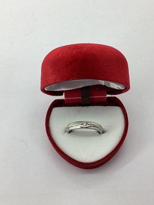 Lot 60 - A Modern Inset Band, the claw set highlight...