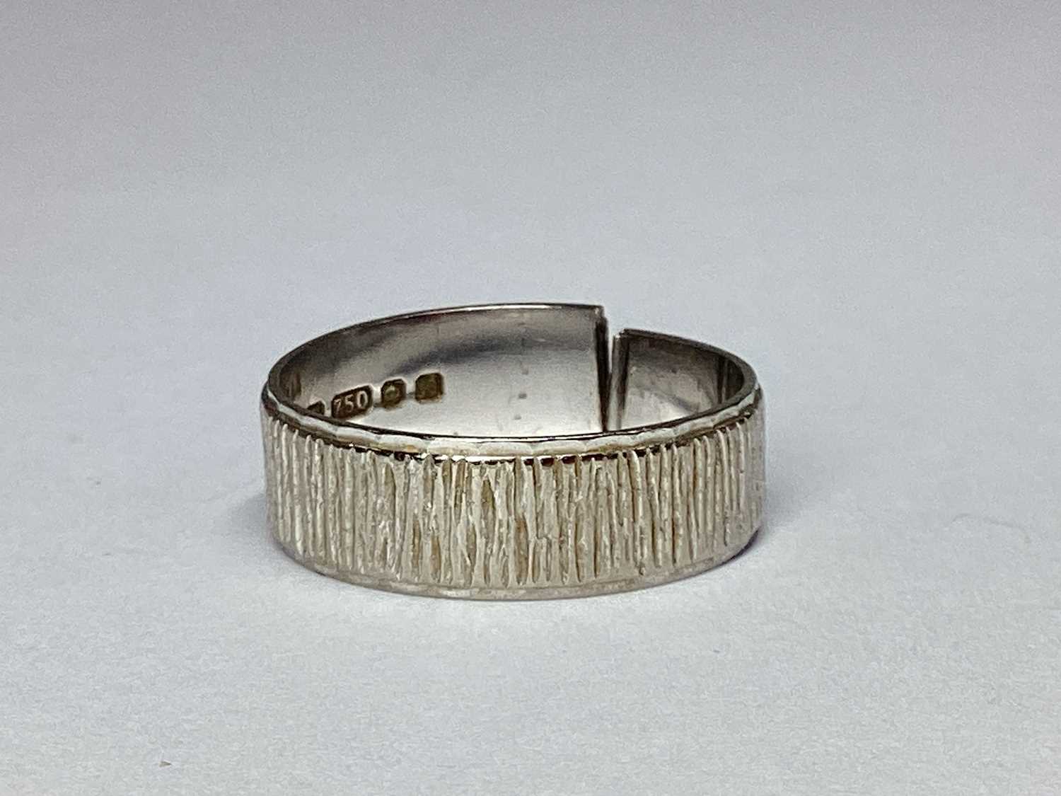 Lot 90 - An 18ct White Gold Bark Effect Wedding Band...