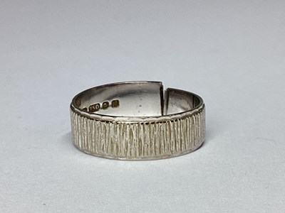 Lot 90 - An 18ct White Gold Bark Effect Wedding Band...