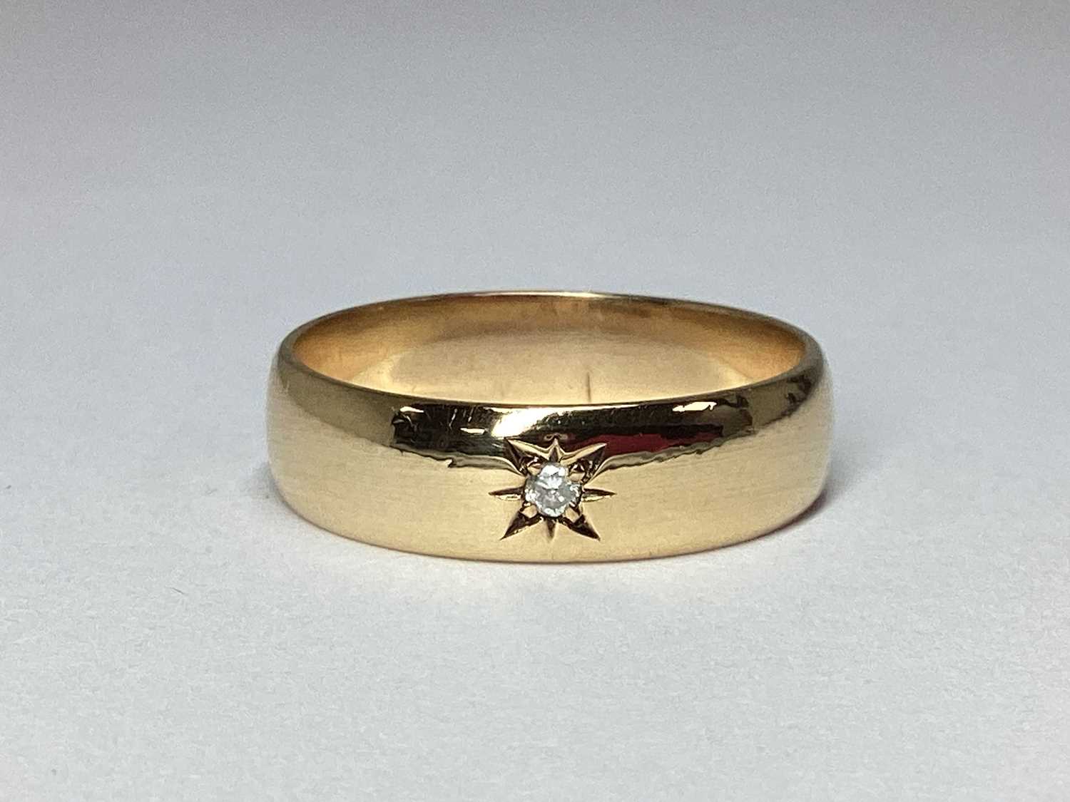 Lot 56 - A 9ct Gold Band, with single star set...