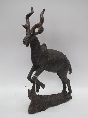 Lot 1389 - An African hand-carved hardwood statue of a...