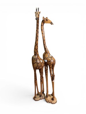 Lot 1469 - A pair of hand-carved wooden giraffe figures,...